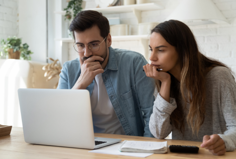 SMG Financial couple with laptop financial analyzer